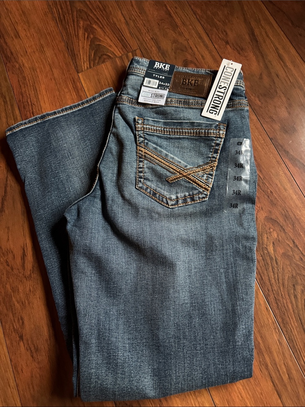 BKE Men's Relaxed Fit Denim Jeans in Faded Blue with Tan Stitching